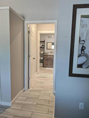 an empty hallway with a hallway leading into a room at New modern and chic and upscale apartment in Maryville