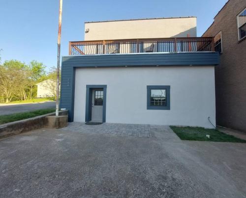 a white building with a balcony on top of it at New modern and chic and upscale apartment in Maryville