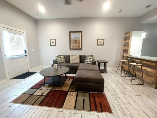 a living room with a couch and a table at New modern and chic and upscale apartment in Maryville
