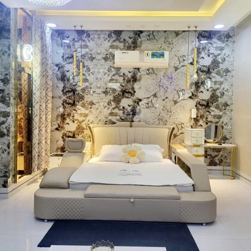 a bedroom with a bed with a teddy bear on it at Luxury 6 bedrooms villa with private swimming pool in Ajman