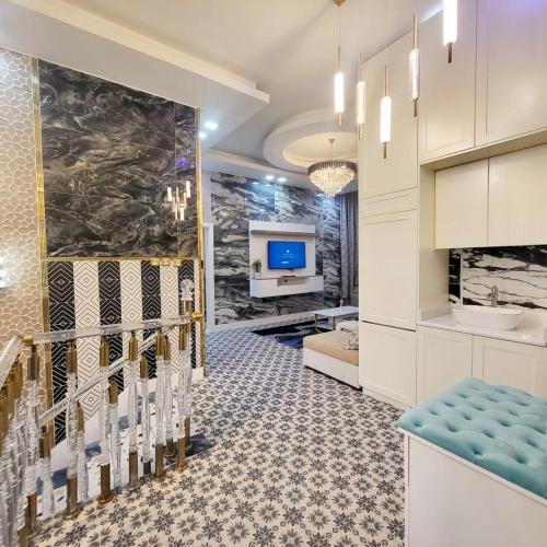 a lobby of a hotel with a waiting room with a tv at Luxury 6 bedrooms villa with private swimming pool in Ajman