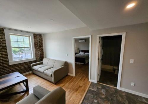 a living room with a couch and a bed at Modern 2BR in Great Location (202) in Maryville