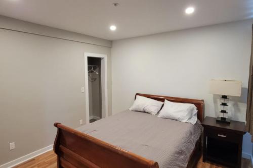 a bedroom with a bed and a night stand with a lamp at Modern 2BR in Great Location (202) in Maryville