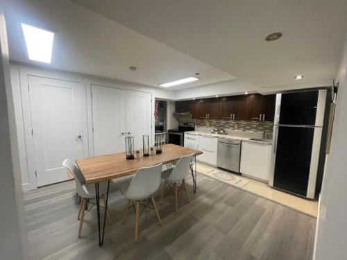 a large kitchen with a wooden table and chairs at Brand New - Tranquil Retreat in Halifax