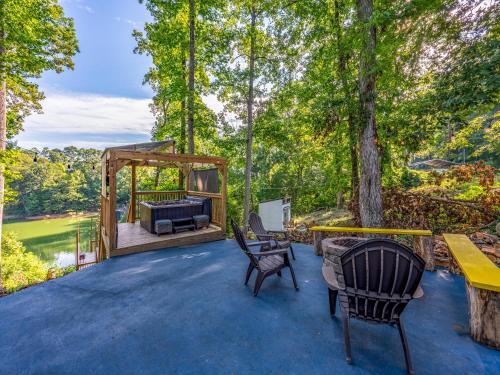 an outdoor patio with a grill and chairs at Emerald Cove in Dandridge