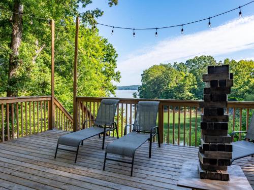 a deck with chairs and a fire place with a view at Emerald Cove in Dandridge