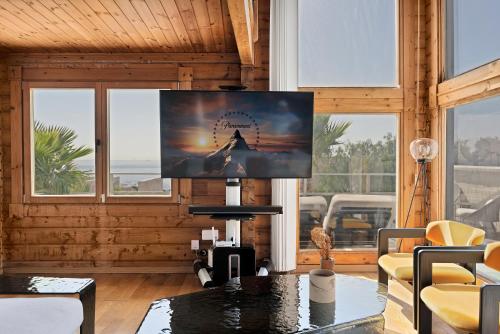 a living room with a flat screen tv on a wall at Increíble Villa de madera con vistas al mar in Algeciras