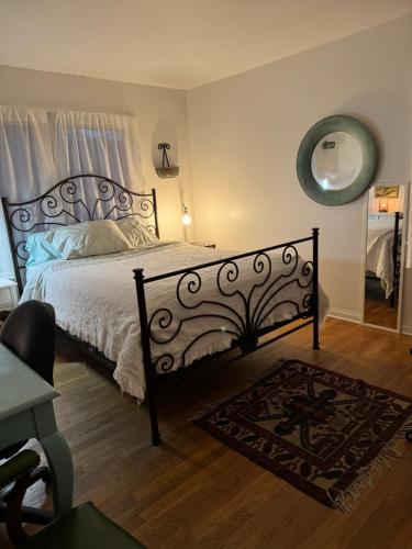 a bedroom with a large bed and a mirror at Spacious Room with a View of the Woods in Armonk