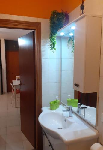 a bathroom with a sink and a mirror at Casa Dellestate in Grottammare