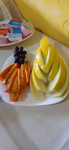 a plate of fruit and vegetables on a table at Pousada Mare Blue in Búzios
