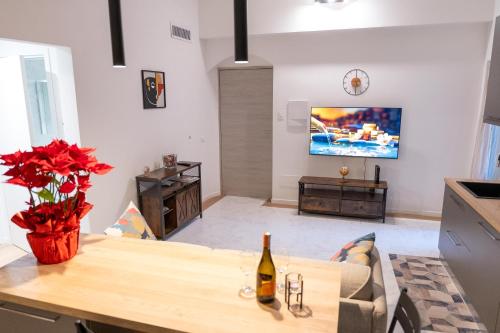 a living room with a table with a bottle of wine at L'ANGOLO di GALILEO in Pisa