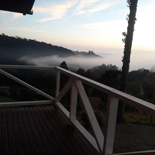a view from the deck of a house in the mist at Cabana Sítio Costãozinho in Bom Retiro