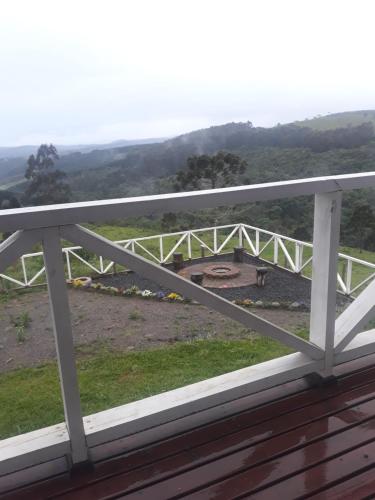 a view of a white bridge from a balcony at Cabana Sítio Costãozinho in Bom Retiro