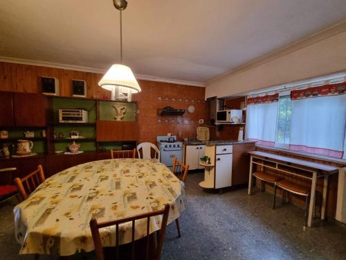 a kitchen and a dining room with a table in a room at Casa Mardel in Mar del Plata