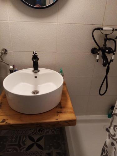 a bathroom with a white sink and a tub at Villa Nono in Vrh