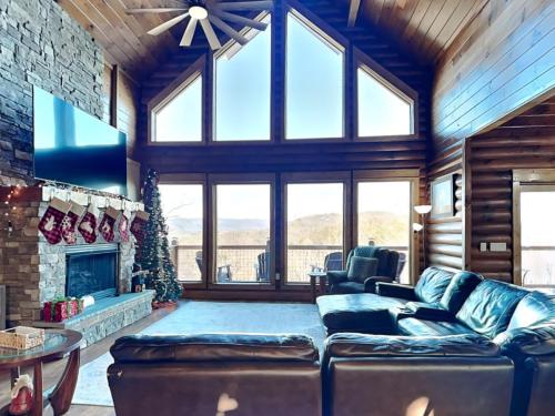 a living room with a couch and a fireplace at 5 Solas Lodge in Sevierville
