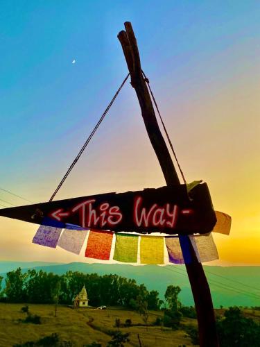 a sign that says this way hanging on a pole at The Flag Villa in Kas
