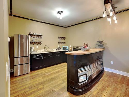 a large kitchen with a counter and a refrigerator at 5 Solas Lodge in Sevierville