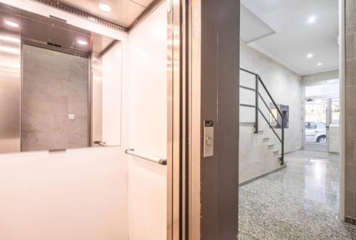a hallway with a glass door and a stairway at Vistas Laterales al Mar de Moraira 2 Hab Wifi in Moraira