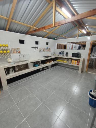 a large kitchen with a sink and a counter at Finca El Encanto del Guejar in Lejanías