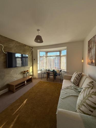 a living room with a couch and a table at Private Spacious One-Bedroom Flat - Located Between the City Centre and the New Forest in Totton