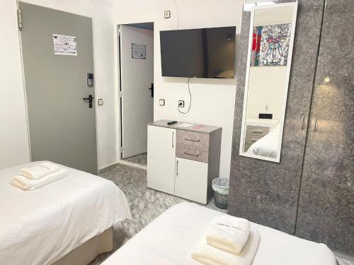 a hotel room with two beds and a tv at Hotel Arganda in Arganda del Rey