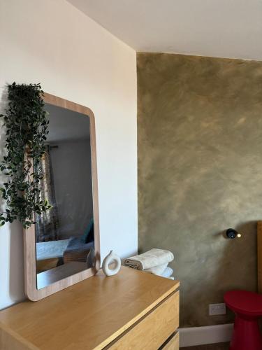 a bathroom with a mirror and a wooden dresser at Private Spacious One-Bedroom Flat - Located Between the City Centre and the New Forest in Totton