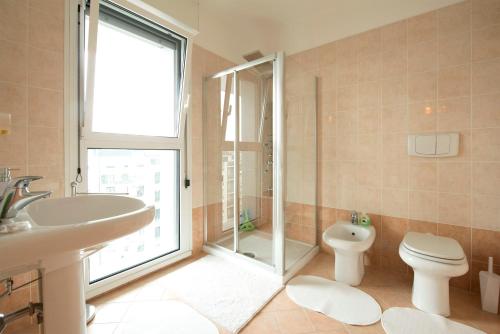 y baño con aseo, lavabo y ducha. en New Luxury Attic Santa Giulia Expo, en Milán