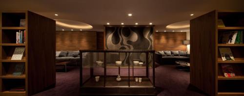 a living room with a couch and a table with candles at Furuyu Onsen Oncri in Saga