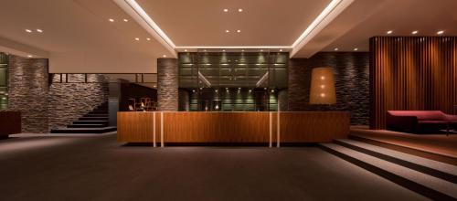 a lobby of a hotel with a reception desk at Furuyu Onsen Oncri in Saga