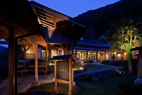 a building with a sign in front of it at night at Furuyu Onsen Oncri in Saga