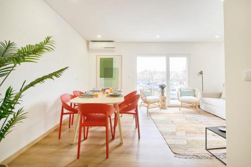 a dining room with a table and chairs at Beachside Modern Flat with AC, By TimeCooler in Setúbal