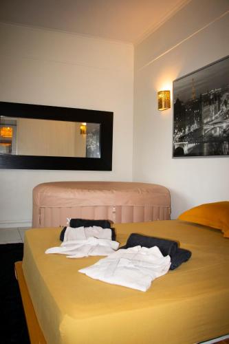 une chambre avec un lit avec des serviettes dessus dans l'établissement Paris By Night, à Bagnolet