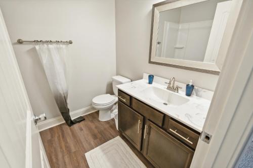 a bathroom with a sink and a toilet and a mirror at Biltmore Luxury 1513 #3 Townhomes L 2bd 2 Bth in Clarksville