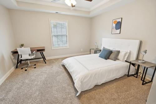 a bedroom with a white bed and a desk and a computer at Biltmore Luxury 1513 #3 Townhomes L 2bd 2 Bth in Clarksville