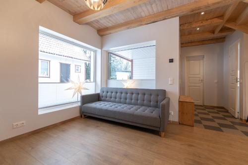 a living room with a couch and a window at CozyStay in Otepää