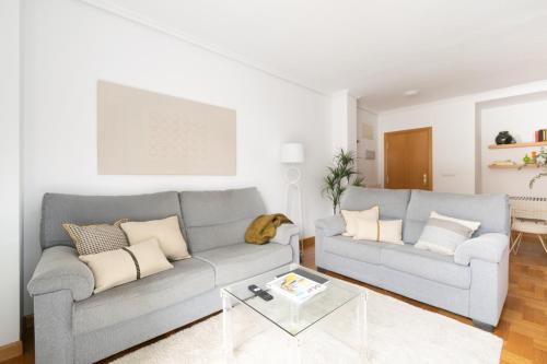 a living room with two couches and a table at Yesa by Clabao in Yesa