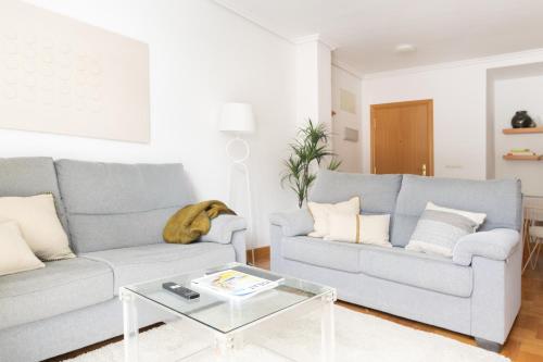 a living room with two couches and a coffee table at Yesa by Clabao in Yesa