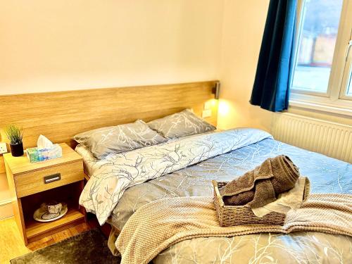a bedroom with a bed and a wooden headboard at Stay 45A in London