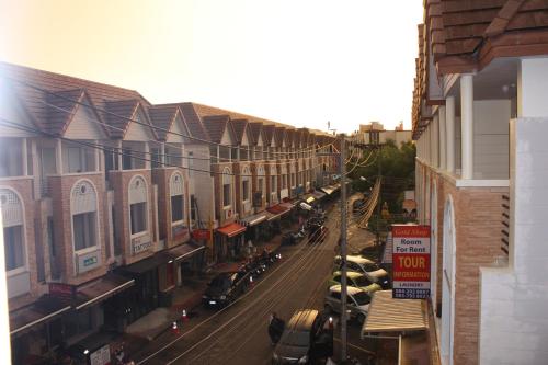 a city street with cars parked on the street at Phuket Racha Kata Homestay in Kata Beach