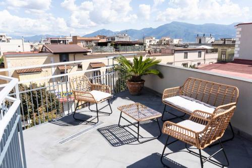 a patio with chairs and tables on a balcony at Palazzo Vitiello in Boscotrecase