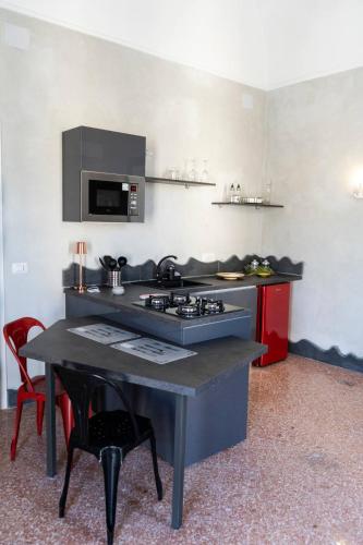 a kitchen with a table with a stove and a counter top at Palazzo Vitiello in Boscotrecase