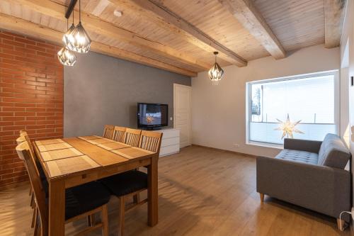 a dining room with a table and a couch at CozyStay in Otepää