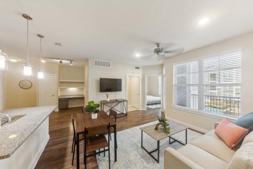 a living room with a couch and a table at Cullen 3211 I New Construction 2bd Apt I Gated in Houston