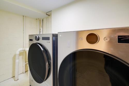 a microwave and a dryer in a room at 1 Mi to Metro DC Area Apt with Fenced Yard! in Silver Spring