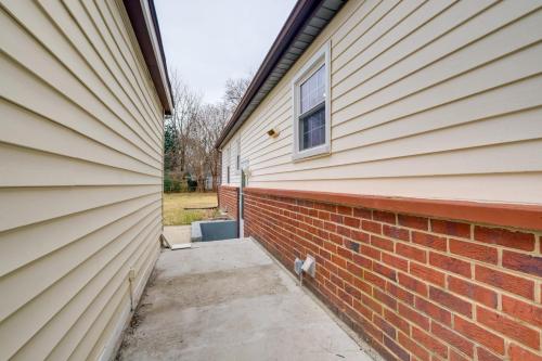 a side of a house with a brick wall at 1 Mi to Metro DC Area Apt with Fenced Yard! in Silver Spring
