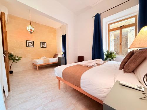 a hotel room with a bed and a desk at Gardjola House by Holi in Senglea