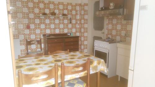 a small kitchen with a table and a stove at DAVANTI AL MARE, FRA PORTOFINO E LE 5 TERRE - IN FRONT Of THE SEA, BETWEEN PORTOFINO AND THE 5 TERRE in Zoagli