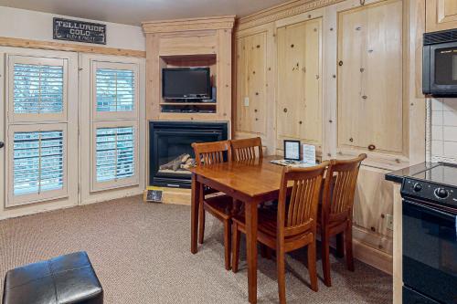 a kitchen with a table and chairs and a fireplace at Viking Lodge B218 in Telluride