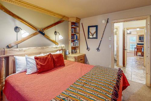 a bedroom with a bed with a red comforter at Viking Lodge B218 in Telluride